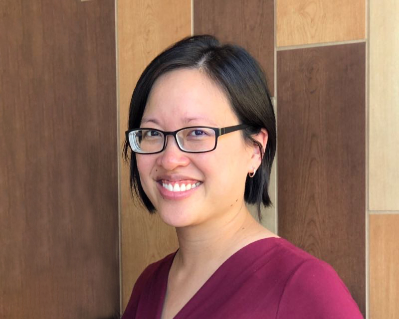 Chanlee Sutoyo smiling in glasses and a burgundy top
